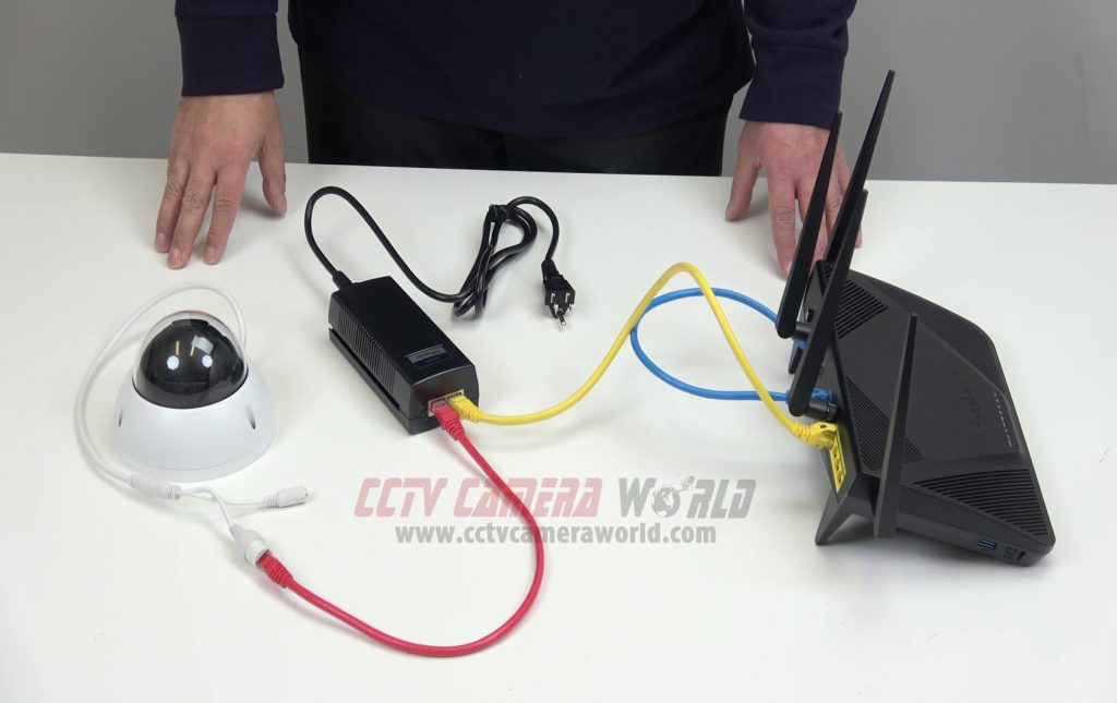 Setup showing PTZ camera with PoE injector connected to router for internet connectivity