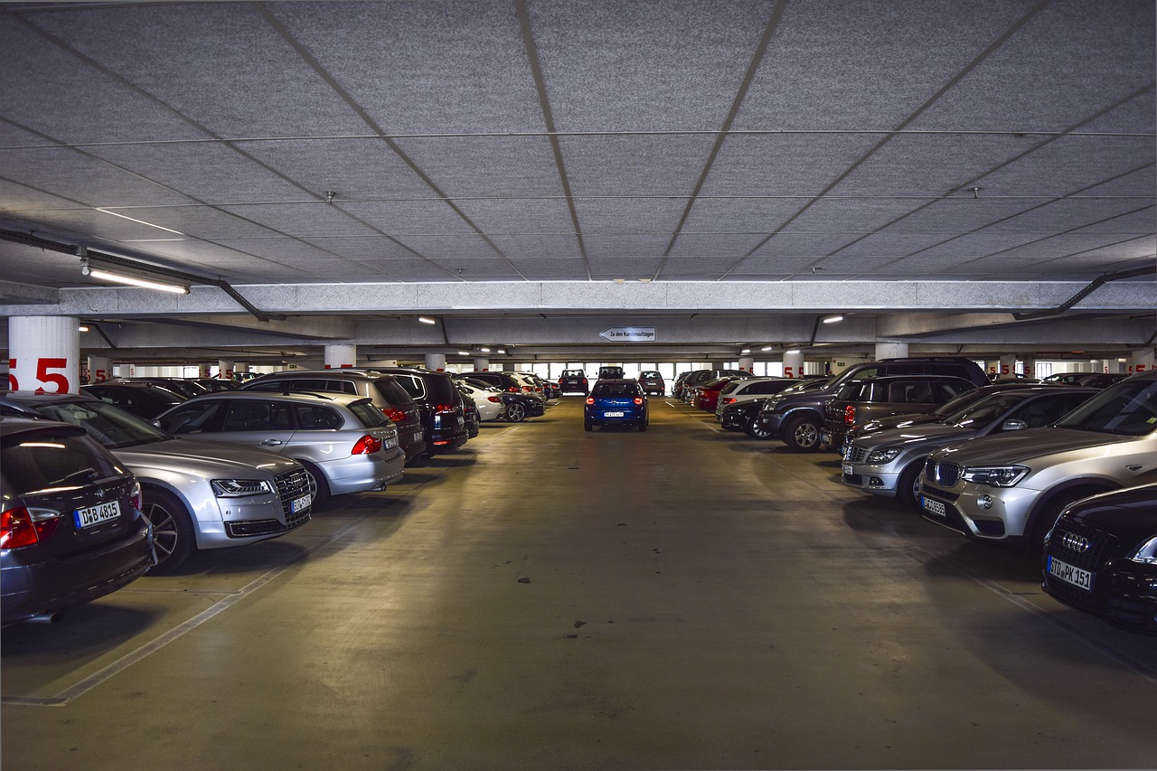 The inside of a parking garage with a car driving ahead