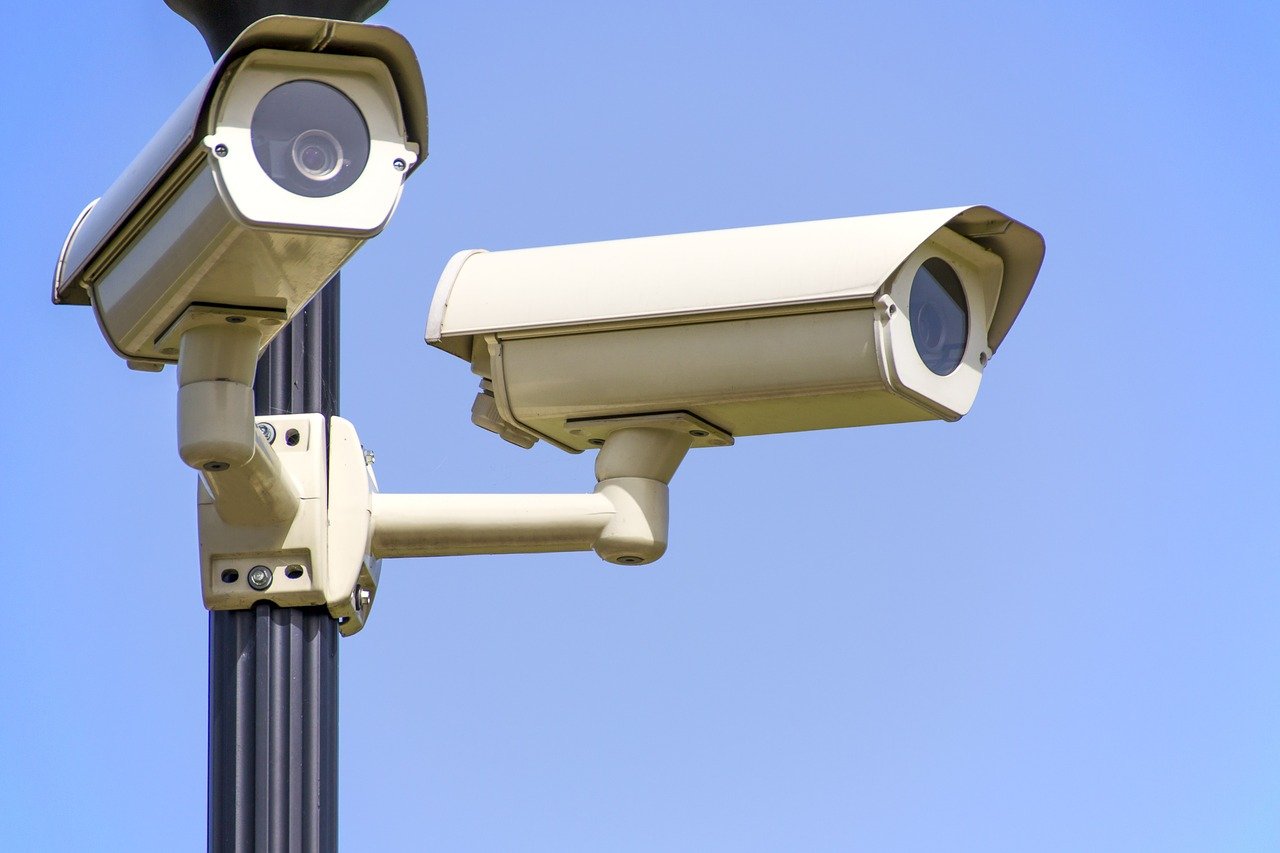 Two security cameras mounted to a pole