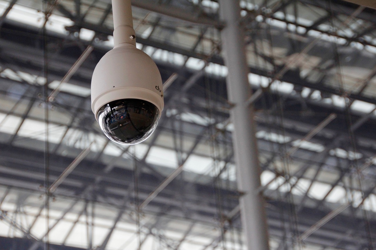 A dome security camera mounted to a hanging pole