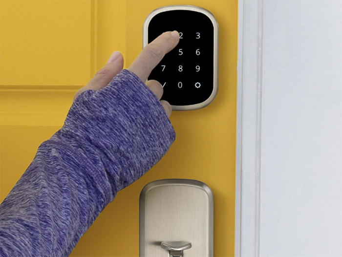 Woman using keypad to open door lock