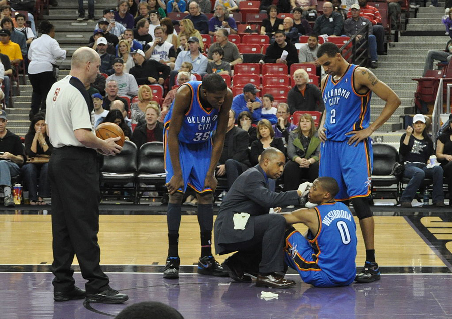NBA Player Russell Westbrook being attended to by players and staff after injury